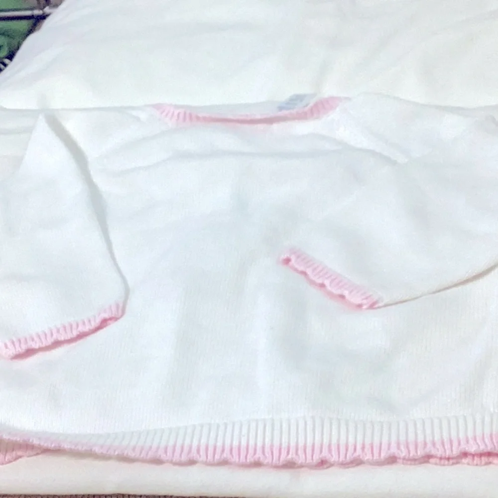Carter’s white sweater with pink trim on neck, sleeve and hem. 12 months